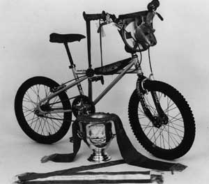 Quad with ribbons and trophy: This was a publicity shot of my Quadangle that I won the Austrailian Gran Prix Trophy Dash with in 1980. The silver cup was for the American team victory, clinched by my win. I still have the ribbons in a framed display at home. It was a special moment for me to come out of retirement and smoke the top Pros in the World.